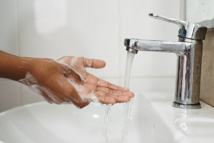 person washing hands for 30 seconds as suggested by the CDC to stop the spread of coronavirus or COVID-19. Related to California COVID-19 legislation.